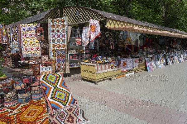 Carpet stand at a market with colorful patterns, cloths and souvenirs in an open setting, vernissage market, craft market, Yerevan, Yerevan, Yerevan, Armenia