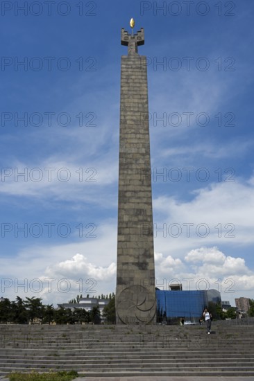 Tall stone column with symbolically decorated top under blue sky, memorial to 50 years of Soviet Armenia, Yerevan, Yerevan, Yerevan, Armenia