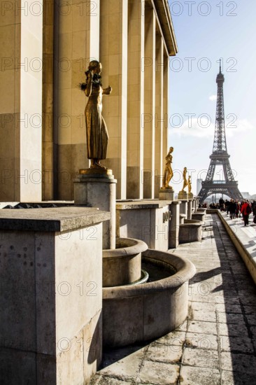 Gilded bronze statues at Palais de Chaillot and Eiffel Tower (Tour Eiffel) in the background. Paris, France. 30.12.12