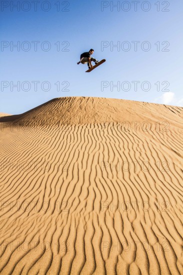 Sandboarding in Cerro Dragon, in Atacama Desert. Iquique, Tarapaca Region, Chile
