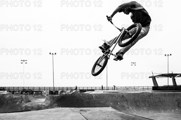 Young man jumping with a bicycle at Skatepark, in Playa Brava. Iquique, Tarapaca Region, Chile. 16.11.15