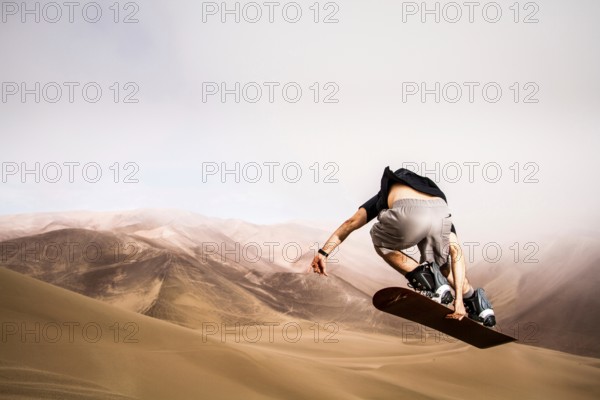 Sandboarding on Atacama Desert. Iquique, Tarapaca Region, Chile