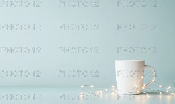 A white coffee cup sits on a table next to a string of lights. The scene is simple and calming, with the white cup and lights creating a sense of warmth and comfort. AI generated