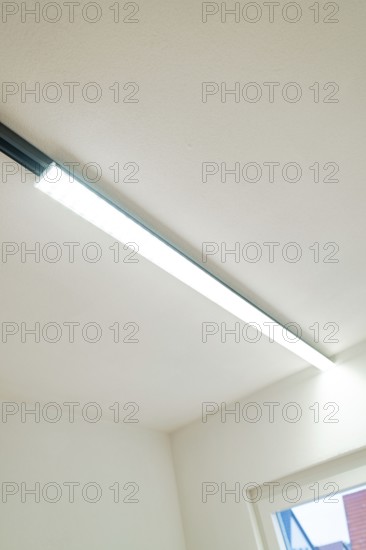 Slim LED light strip on white ceiling next to a window, clear and modern, house renovation, energy renovation, Metzingen, Germany