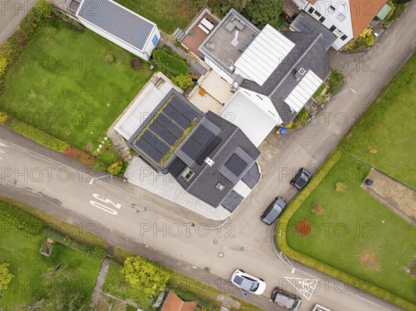 Aerial view of a residential area with house and photovoltaic, green gardens and traffic-calmed street, house renovation, energy renovation, Metzingen, Germany