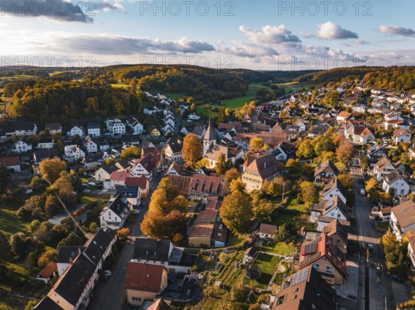 A village with church and colorful autumn trees under a blue sky, Deufringen, Aidlingen, Böblingen district, Germany