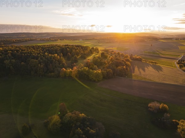 Aerial view of peaceful autumn landscape with sunset in the background, Venusberg, Aidlingen, Germany