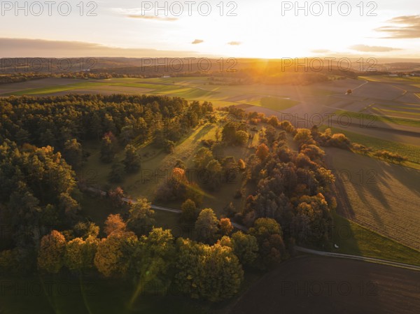 Autumn forest and fields in warm evening light, seen from the air, Venusberg, Aidlingen, Germany