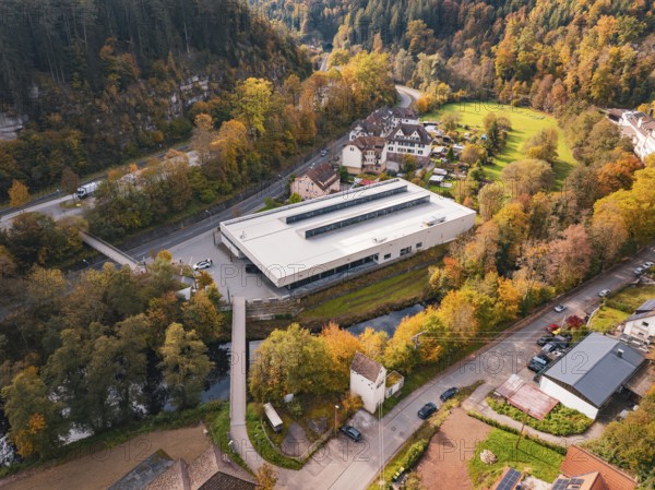Sports hall in a valley landscape, surrounded by thick forests and a small river, Walter Lindner Sporthalle Calw, Black Forest, Germany