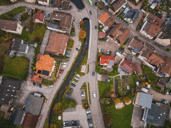 Aerial view of a village from above, showing roads, houses, a river and autumn trees, Calmbach, Bad Wildbad, Black Forest, Germany