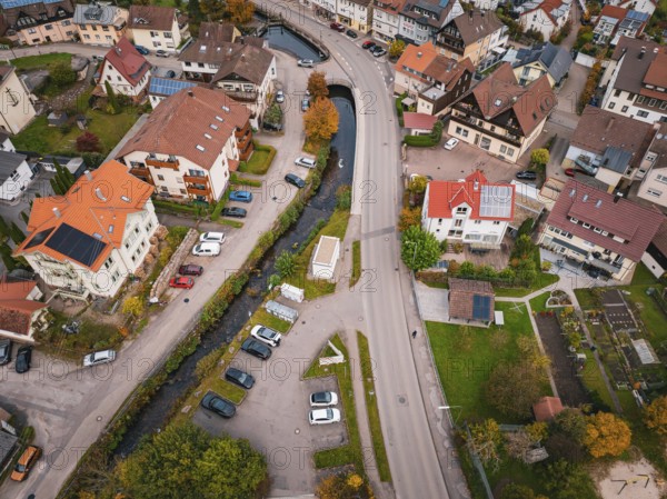 Urban aerial view of an area with a river, parked cars and lush autumn leaves, Calmbach, Bad Wildbad, Black Forest, Germany