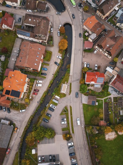 Aerial view of a village with a river running between autumn trees and houses, Calmbach, Bad Wildbad, Black Forest, Germany