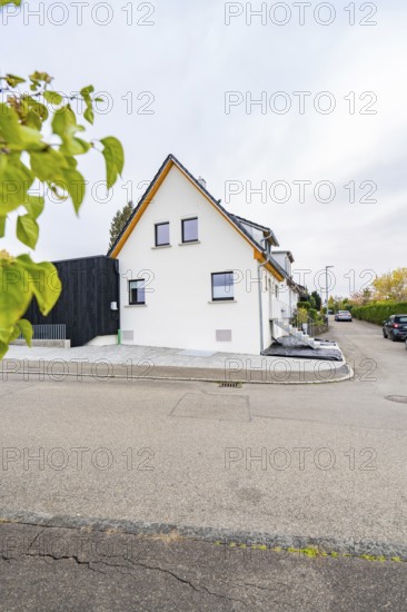 Gable view of a semi-detached house on a quiet residential street with minimalistic design, house renovation, climate renovation, Metzingen, Germany