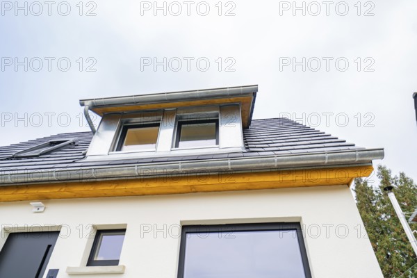 Detailed view of a modern dormer with zinc and wood under overcast sky, house renovation, climate renovation, Metzingen, Germany