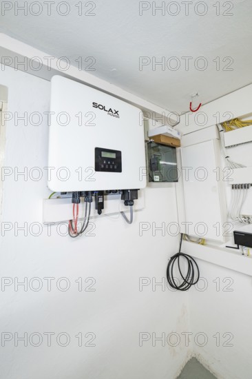 Wall-mounted SOLAX inverter in bright technical room, house renovation, climate renovation, Metzingen, Germany
