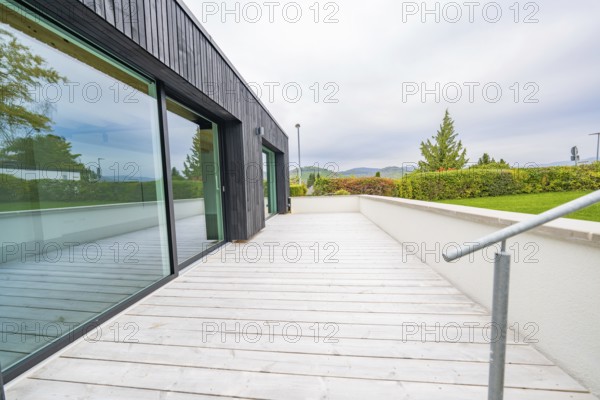 Wide terrace with wooden flooring and views of the countryside under overcast sky, house renovation, air-conditioning renovation, Metzingen, Germany