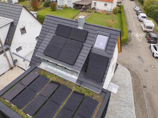 Close-up of anthracite-colored gable roof with several PV fields, skylight and fireplace, house renovation, climate renovation, Metzingen, Germany