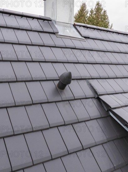 Roof detail with vent pipe on sealed fireplace area, house renovation, air conditioning renovation, Metzingen, Germany