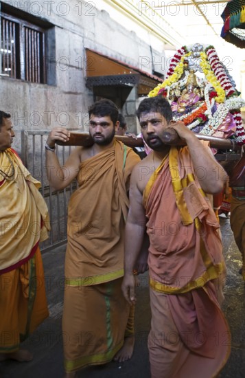 Puja at Chamundeswar Hindu Temple on Chamundi Hill, Indian men wear the statue of a Hindu goddess, Mysore or Mysore, Karnataka, India