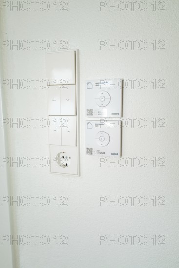 Wall panel with light switches, power outlet and smart home control in simple white, house renovation, climate renovation, Metzingen, Germany