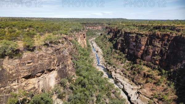 A calm creek flowing through a canyon in the Australian outback, photographed with a drone