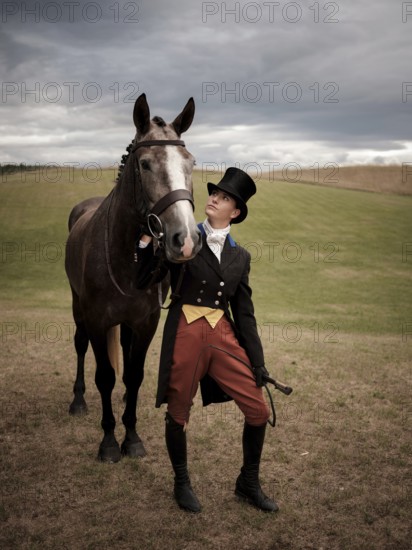 A rider from the Toronto North York Hunt Club, dressed in traditional hunting clothes and her mount, prior to a club event on August 26, 2025, in Mulmer, Ontario, Canada