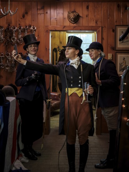 A rider from the Toronto North York Hunt Club, dressed in traditional hunting clothes, take a selfie prior to a club event on August 26, 2025, in Mulmer, Ontario, Canada