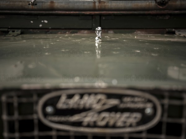 The front end of a 1950's Series One Land Rover, with a small hood ornament, parked at the Toronto North York Hunt Club in Mulmer, Ontario, Canada