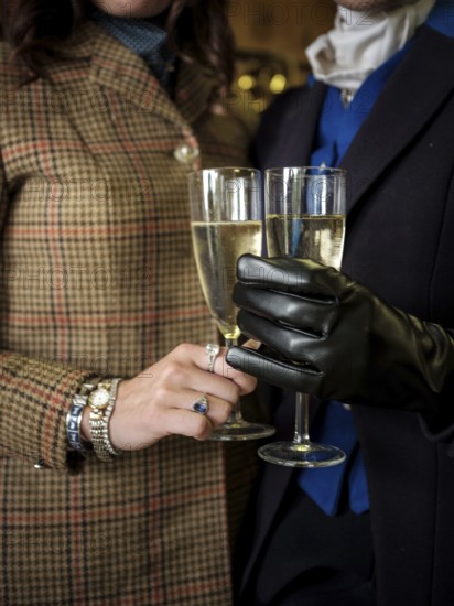 Members of the Toronto North York Hunt Club, dressed in traditional hunting clothes, enjoy a glass of champagne before a ride on August 26, 2025, in Mulmer, Ontario, Canada