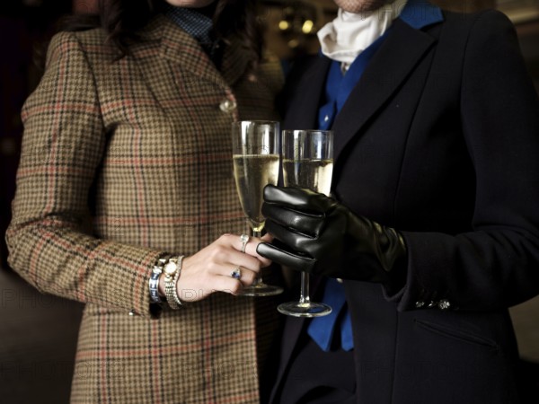 Members of the Toronto North York Hunt Club, dressed in traditional hunting clothes, enjoy a glass of champagne before a ride on August 26, 2025, in Mulmer, Ontario, Canada
