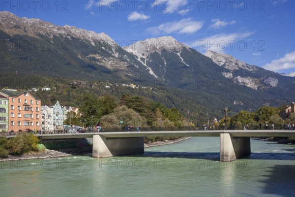 Colourful row of houses in Mariahilfstraße on the Inn River, Inn Bridge and mountains of the Karwendel North Range, Old Town, Innsbruck, Tyrol, Austria