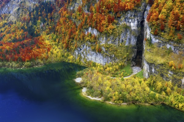 Aerial view of autumn-colored Klöntalersee, rugged rock formation with peninsula, Canton of Glarus, Switzerland