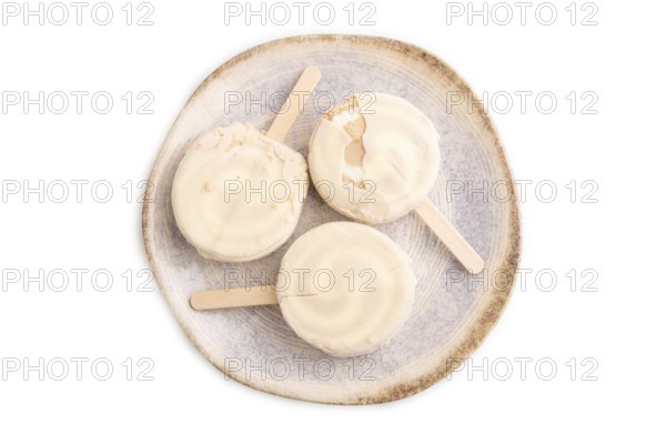 ?hocolate Ice cream in white glaze isolated on white background, top view, flat lay, close up, minimalism