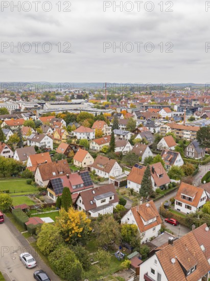 Autumn residential district with red roofs and solar panels under overcast sky, Metzingen, Germany