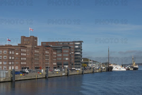 Former warehouse in the port of Kiel, apartments, services, red brick building, architecture, wharf, flags, ships, Kiel Fjord, Schleswig-Holstein, Germany