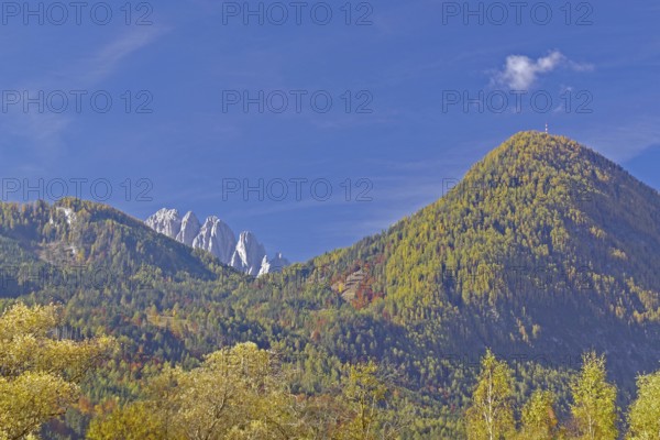 Autumn alpine slopes with round and jagged peaks under clear, deep blue sky, Lienz Dolomites, Drau cycle path, Tyrol, Austria