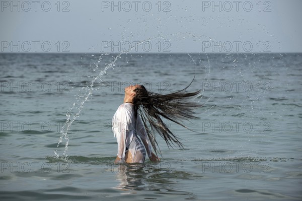 Woman with long hairs in the sea