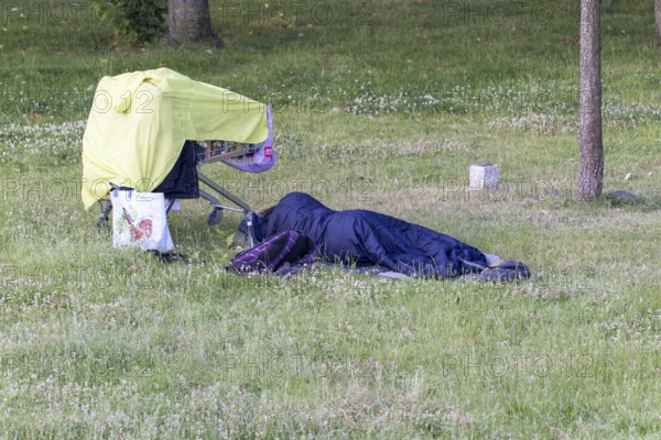Sleeping homeless person with his belongings, North Rhine-Westphalia, Germany