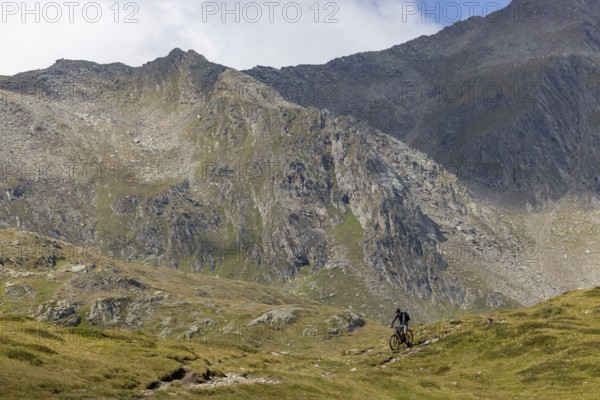Mountain biker on the trail downhill at Passo del Sole, Olivone, Tessin, Switzerland