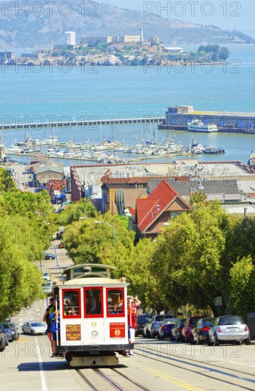 Powell-Hyde line cable car with Alcatraz Island in the background, San Francisco, California, USA