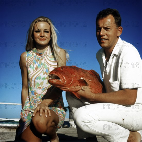 Couple posing with a trout grouper (Plectropomus pessuliferus), Red Sea, 1960s, Egypt