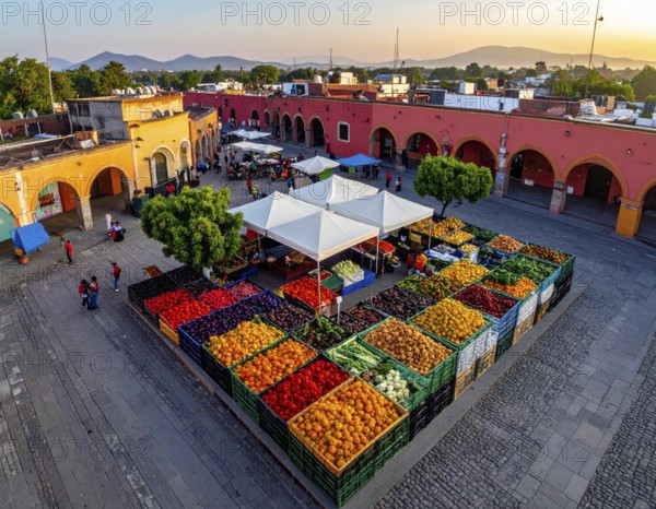 Traditional Mexican plaza with crates of peppers, onions, and tomatoes, economic prosperity in local trade, travel destination in America, AI generated
