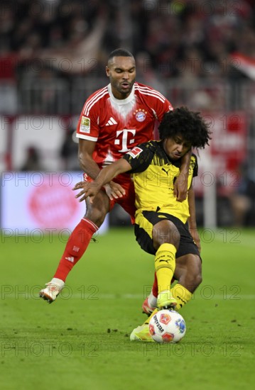 Duel, action Jonathan Tah FC Bayern Munich FCB (04) against Karim Adeyemi Borussia Dortmund BVB (27) German Classico, FC Bayern Munich FCB against Borussia Dortmund BVB, Allianz Arena, Munich, Bayern, Germany