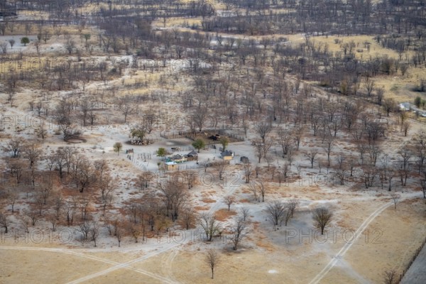 Houses in a dry savanna landscape, near Maun, aerial view, Okavango Delta, Botswana