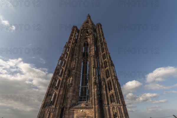 Strasbourg's Gothic cathedral stands majestically under a cloudy sky and gives the scene a unique charm. Bas Rhin, Alsace, France