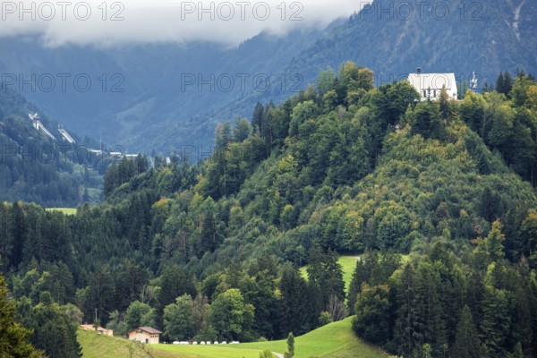 Schöllanger Castle Church, back left ski jumping hills of the Orlen Arena in Oberstdorf, Oberallgäu, Allgäu, Bavaria, Germany