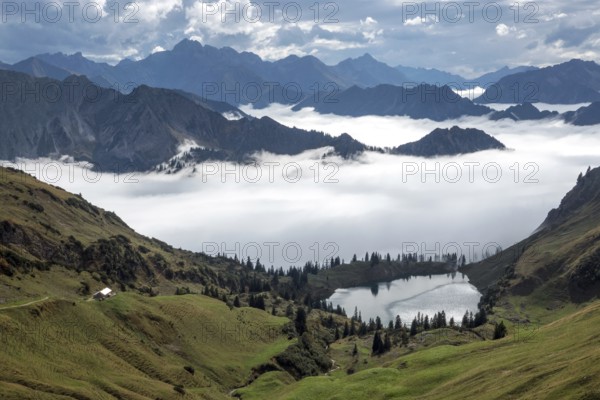 View of Seealpsee and Allgäu Alps, mountains rising from fog in the valley, Nebelhorn, Oberstdorf, Oberallgäu, Allgäu, Bavaria, Germany