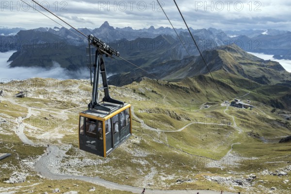 View from Nebelhorn summit to Nebelhorn cable car cabin, mountains of the Allgäu Alps behind, Hochvogel back left, mountains rising from fog in the valley, Oberstdorf, Oberallgäu, Allgäu, Bavaria, Germany