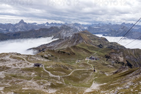 View from Nebelhorn summit to Höfatsblick Nebelhornbahn station and mountains of the Allgäu Alps, back left Hochvogel, mountains rise from fog in the valley, Oberstdorf, Oberallgäu, Allgäu, Bavaria, Germany
