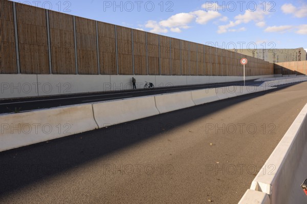 A man urinates next to his bicycle on the A100 during the bicycle demo on the recently inaugurated 16th construction phase of the A100, Berlin, 18.10.2025